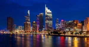 A dazzling night skyline featuring high-rise towers reflected in calm waterfronts, symbolizing the rapid rise and glowing success of Israeli healthtech and AI startups after securing multimillion-dollar investments on the global stage.